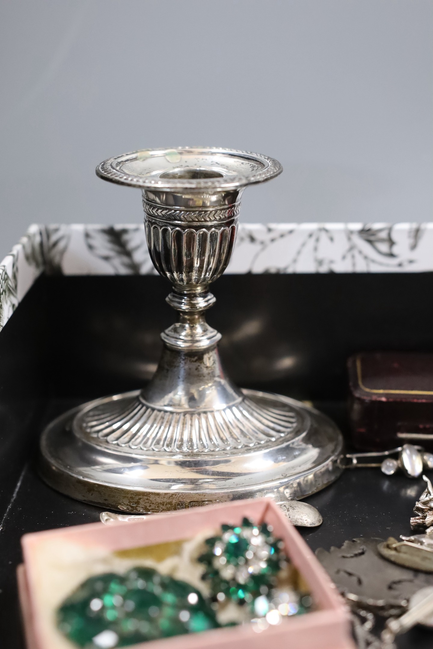 Mixed costume jewellery and other items including silver charm bracelet and silver and enamel baby brooch, Maundy money and a silver mounted dwarf candlestick.